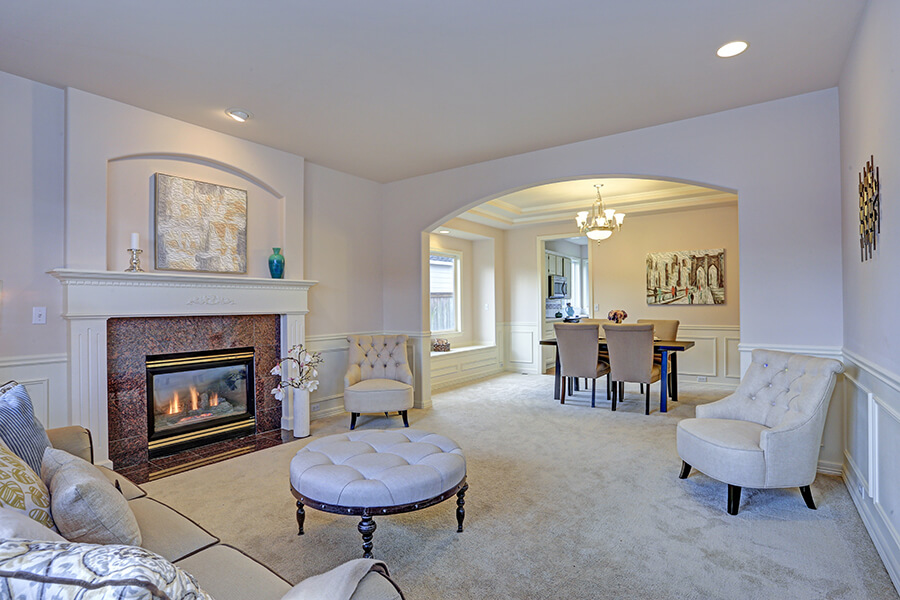 living room with white mantel and millwork
