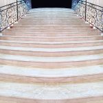 magnificent light marble staircase with ornate metal railings