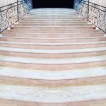 magnificent light marble staircase with ornate metal railings